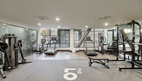 Oakland apartment for rent - A gym with a variety of equipment including treadmills, weights, and exercise machines.