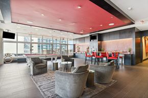 Dallas apartment for rent - A modern living room with a red ceiling and grey walls.