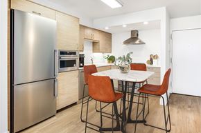 Boston apartment for rent - A modern kitchen with a table and chairs.