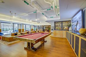 San Francisco apartment for rent - A pool table is in the middle of a room with a wooden floor.