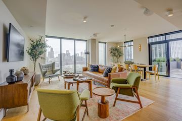 San Francisco apartment for rent - A living room with a green chair in the foreground.