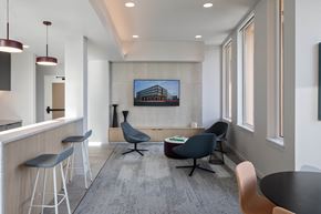 Beaverton apartment for rent - a living room with a table and chairs and a television on the wall