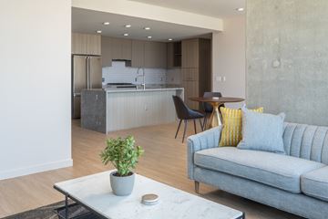 San Diego apartment for rent - A modern living room with a grey couch and a coffee table.