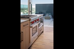 San Diego apartment for rent - A modern kitchen with wooden cabinets and stainless steel appliances.