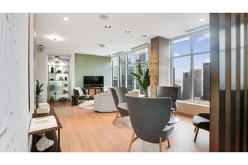 Seattle apartment for rent - A modern living room with a grey sofa and a wooden coffee table.
