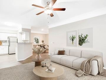 Pearland apartment for rent - A living room with a white couch and a ceiling fan.