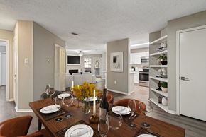 Irving apartment for rent - the living room and dining room of an apartment with a wooden table and chairs