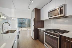 Chicago apartment for rent - a kitchen with a sink and a stove and a microwave