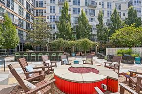 Pittsburgh apartment for rent - A red hot tub sits in the middle of a patio surrounded by chairs.