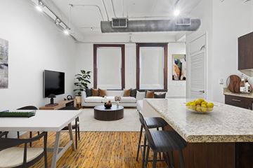 Dallas apartment for rent - A modern kitchen and living room with a dining table and chairs.