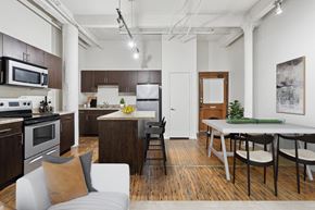 Dallas apartment for rent - A modern kitchen with a dining table and chairs.