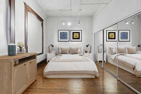 Dallas apartment for rent - A bedroom with a large bed and a wooden dresser.