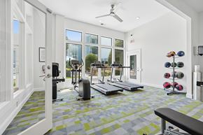 Charlotte apartment for rent - A gym with a variety of equipment including weights and treadmills.