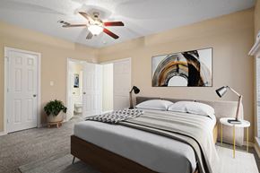 Garland apartment for rent - A bedroom with a large bed and a ceiling fan.
