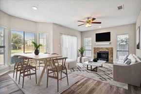 Garland apartment for rent - A living room with a fireplace and a television.