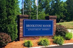 Milford apartment for rent - a sign for the brookstone manor apartment homes