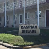 West Burlington apartment for rent - A sign that says Caspian Village in front of a building.