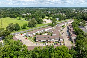 Baton Rouge apartment for rent - A bird's eye view of a residential area with houses and cars.