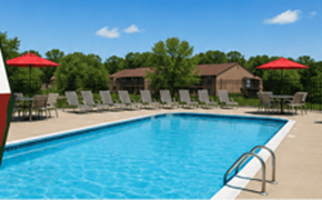 Bloomington apartment for rent - A large swimming pool with a metal ladder and red umbrellas.