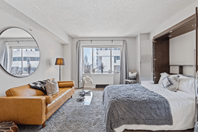 Atlanta apartment for rent - A bedroom with a large bed and a couch.