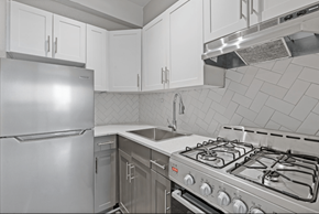Atlanta apartment for rent - A modern kitchen with a stainless steel refrigerator, oven, and range hood.