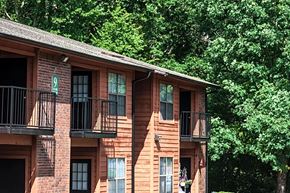 Little Rock apartment for rent - a brick apartment building with balconies and trees