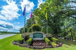 Little Rock apartment for rent - a view of a park with flags and a sign