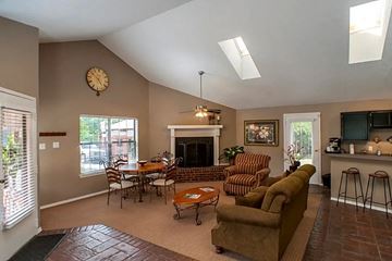 Little Rock apartment for rent - a living room with a couch and a table and a fireplace