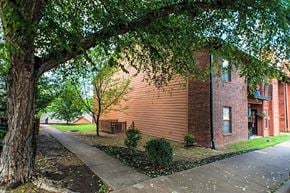 Little Rock apartment for rent - the side of a brick building next to a tree