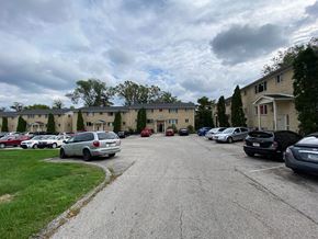 Bloomington apartment for rent - a parking lot with cars in front of apartment buildings