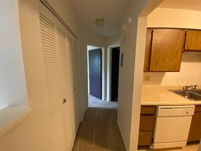 Bloomington apartment for rent - a kitchen with a sink and a door to a hallway