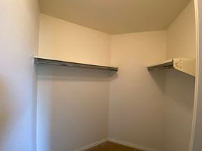 Bloomington apartment for rent - a room with a white wall and a hanging shelf