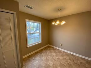 Bloomington apartment for rent - an empty dining room with a window and a chandelier