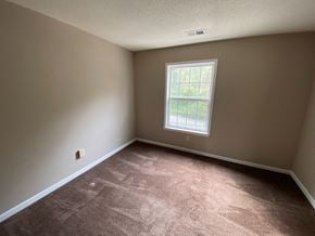 Bloomington apartment for rent - a bedroom with a window and a carpeted floor
