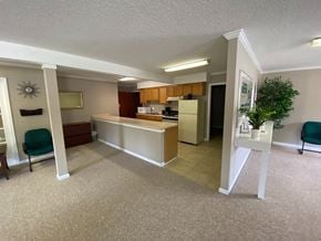 Bloomington apartment for rent - an empty living room with a kitchen and a table