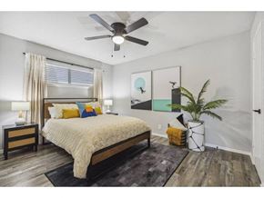 Denton apartment for rent - a bedroom with a bed and a ceiling fan