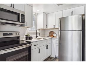 Denton apartment for rent - a kitchen with stainless steel appliances and white cabinets