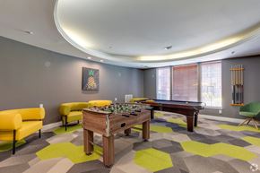 Houston apartment for rent - A room with a pool table and chairs.