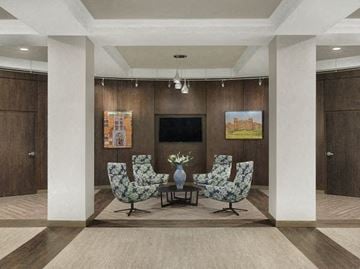 Saint Louis apartment for rent - a living room with a table and chairs and a television