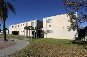 Highland apartment for rent - the exterior of an office building with a sidewalk and grass