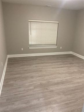 Getzville apartment for rent - an empty room with wooden floors and a window