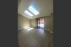 Buffalo apartment for rent - an empty living room with a wood floor and a window