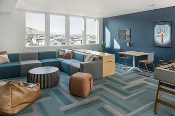 Fairfield apartment for rent - A living room with a blue couch and a brown ottoman.