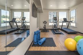 Hayward apartment for rent - A gym with treadmills, exercise balls, and weights.