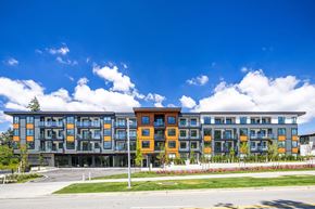 Surrey townhouse for rent - A modern multi-story building with a mix of grey and orange balconies.