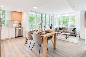 North Vancouver apartment for rent - A modern dining room with a wooden table and chairs.