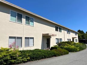 Nanaimo apartment for rent - A building with a red sign on the front door.