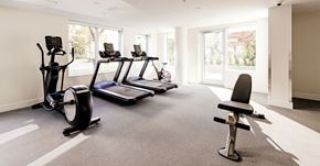 North Vancouver apartment for rent - A home gym with a treadmill, elliptical trainer, and stationary bike.