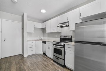 Calgary apartment for rent - A kitchen with white cabinets and appliances.