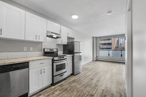 Calgary apartment for rent - A kitchen with white cabinets and stainless steel appliances.